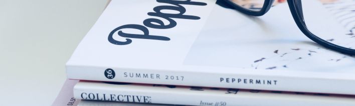 Photo of Eyeglasses On Top of Magazines