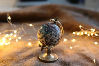 An artistic display of a miniature globe surrounded by glowing string lights.